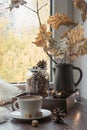 Fall cozy still life on windowsill at home interior. Cup of coffee at home warm fluffy furskin. Hygge.