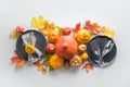 Fall decor for Thanksgiving Day. Cutlery, wineglasses, plate,pumpkins, leaves, apples on grey. Top view. Catering Royalty Free Stock Photo