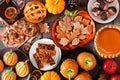 Fall desserts table scene with a mixture of sweet autumn treats over dark wood