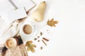 Fall feminine styled composition. Autumn workspace still life. Notebook mock-up scene with cup of coffee, wool blanket