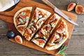 Fall flat bread with figs, caramelized onions, blue cheese and rosemary, overhead table scene on rustic wood Royalty Free Stock Photo