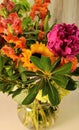 fall flower bouquet in glass vase - purples, orange, yellow, and sunflowers
