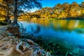 Fall foliage on the crystal clear Frio River in Texas.