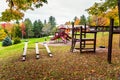 Fall foliage in a deserted children palyground on an autumn morning Royalty Free Stock Photo