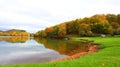 fall foliage forest reflecting in the still surface of lake water, Beautiful Autumn foliage colors above water Royalty Free Stock Photo