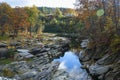 Fall foliage hugs the Ottauquechee River.