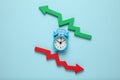 Fall and growth in business. Clock, red arrow down, green - up Royalty Free Stock Photo