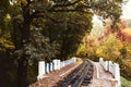 Fall landscape, Railway tracks running through autumn forest Royalty Free Stock Photo