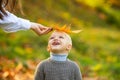 Fall leaves children concept. Cute little boy playing with leaves in autumn park.