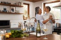 Fall in love all over again. a happy mature couple dancing together while cooking in the kitchen at home. Royalty Free Stock Photo