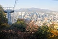 Fall maple leaves foliage Autumn with city apartments scene and cable car tower in Seoul, South Korea Royalty Free Stock Photo