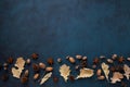Fall oak leaves and acorns border on dark surface