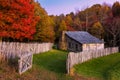 Autumn foliage and rustic cabin in sunset glow