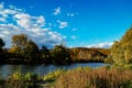 Fall over water , colorful shores , blue sky , white clouds , fall colors Royalty Free Stock Photo