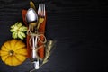 Fall Place setting with a Silver Fork, Mini Pumpkin, and Wheat Grass on Napkin on wooden Table Background, space for copy or your Royalty Free Stock Photo