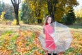 Fall. Portrait of beautiful young woman in autumn park