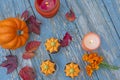 Fall pumpkin spice cupcakes with creamy frosting and autumn toppings candles and autumn leaves . Royalty Free Stock Photo