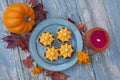 Fall pumpkin spice cupcakes with creamy frosting and autumn toppings candles and autumn leaves . Royalty Free Stock Photo