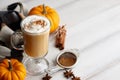 Fall pumpkin spice latte with whipped cream on white wooden background Royalty Free Stock Photo