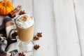 Fall pumpkin spice latte with whipped cream on white wooden background Royalty Free Stock Photo