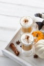 Fall pumpkin spice latte with whipped cream on white wooden background Royalty Free Stock Photo