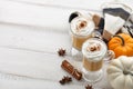 Fall pumpkin spice latte with whipped cream on white wooden background Royalty Free Stock Photo