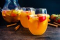 Glasses of Sangria With White Wine, Apples, Pears, and Cinnamon