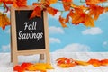 Fall Savings sign with standing chalkboard with fall leaves