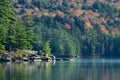 Fall scene of a bright colorful fall leaves and pine trees along the shore of a lake Royalty Free Stock Photo