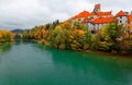 Fall scenery of beautiful Lech River with the majestic landmark architecture, Hohes Schloss Castle, in the background and colorful Royalty Free Stock Photo