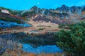 Fall scenery of Senjojiki Cirque in morning twilight with rugged Kiso mountain peaks in background reflected in a pond