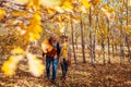 Fall season activities. Senior couple walking in autumn park. Retired man and woman holding hands outdoors Royalty Free Stock Photo