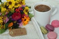 Hello weekend text on label, autumn flowers, coffee mug and macarons