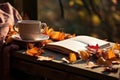 Cup of hot tea and book in the park, autumn leaves , AI Generated Royalty Free Stock Photo