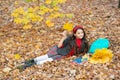 fall season fashion. teen girl in school uniform hold autumn leaves. happy child Royalty Free Stock Photo