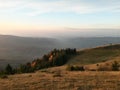 Fall season at the mountain with colorfully trees, meadows and hills