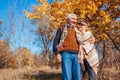 Fall season. Senior couple walking in autumn park. Middle-aged man and woman hugging and relaxing outdoors Royalty Free Stock Photo