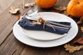 Fall season table setting with leaves and pumpkins Royalty Free Stock Photo