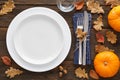 Fall season table setting with pumpkins, leaves and cutlery Royalty Free Stock Photo