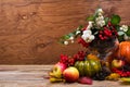 Fall table centerpiece with snowberry, green pumpkin, copy space Royalty Free Stock Photo