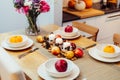 Fall table setting for celebration Thanksgiving day family party. Autumn composition with candles, fruits, nuts and Royalty Free Stock Photo