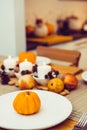 Fall table setting for celebration Thanksgiving day family party. Autumn composition with candles, fruits, nuts and Royalty Free Stock Photo