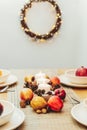 Fall table setting for celebration Thanksgiving day family party. Autumn composition with candles, fruits, nuts and Royalty Free Stock Photo