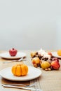 Fall table setting for celebration Thanksgiving day family party. Autumn composition with candles, fruits, nuts and Royalty Free Stock Photo