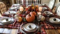 Fall Table Setting with Pumpkins, Candles, and Plaid Tablecloth Royalty Free Stock Photo
