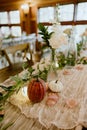 Fall tablescape decor adorned with white flowers and pumpkins Royalty Free Stock Photo