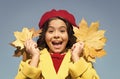 fall time fashion. paris child wear beret. beauty of nature. french kid in autumn. cheerful girl with yellow maple