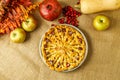 Fall traditional apple pie still life with pumpkin, cranberry and apples.