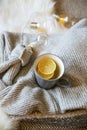 Fall warm tea cup, cup of lemon tea with warm cozy sweaters and scarf, cozy home interior