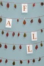 Fall word and autumn leaves hanging on strings Royalty Free Stock Photo